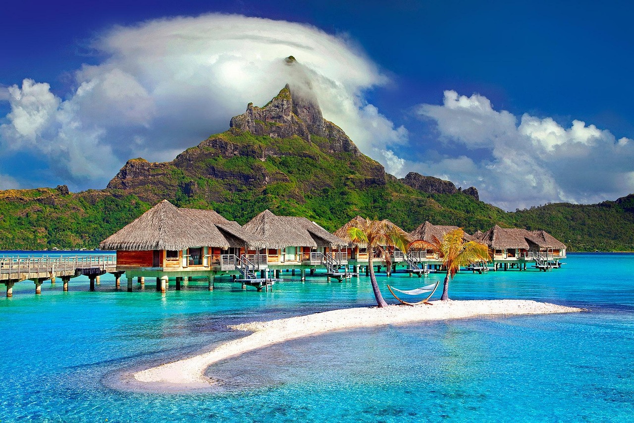 Stunning view of Bora Bora, French Polynesia, with its crystal-clear waters, overwater bungalows, and Mount Otemanu in the background