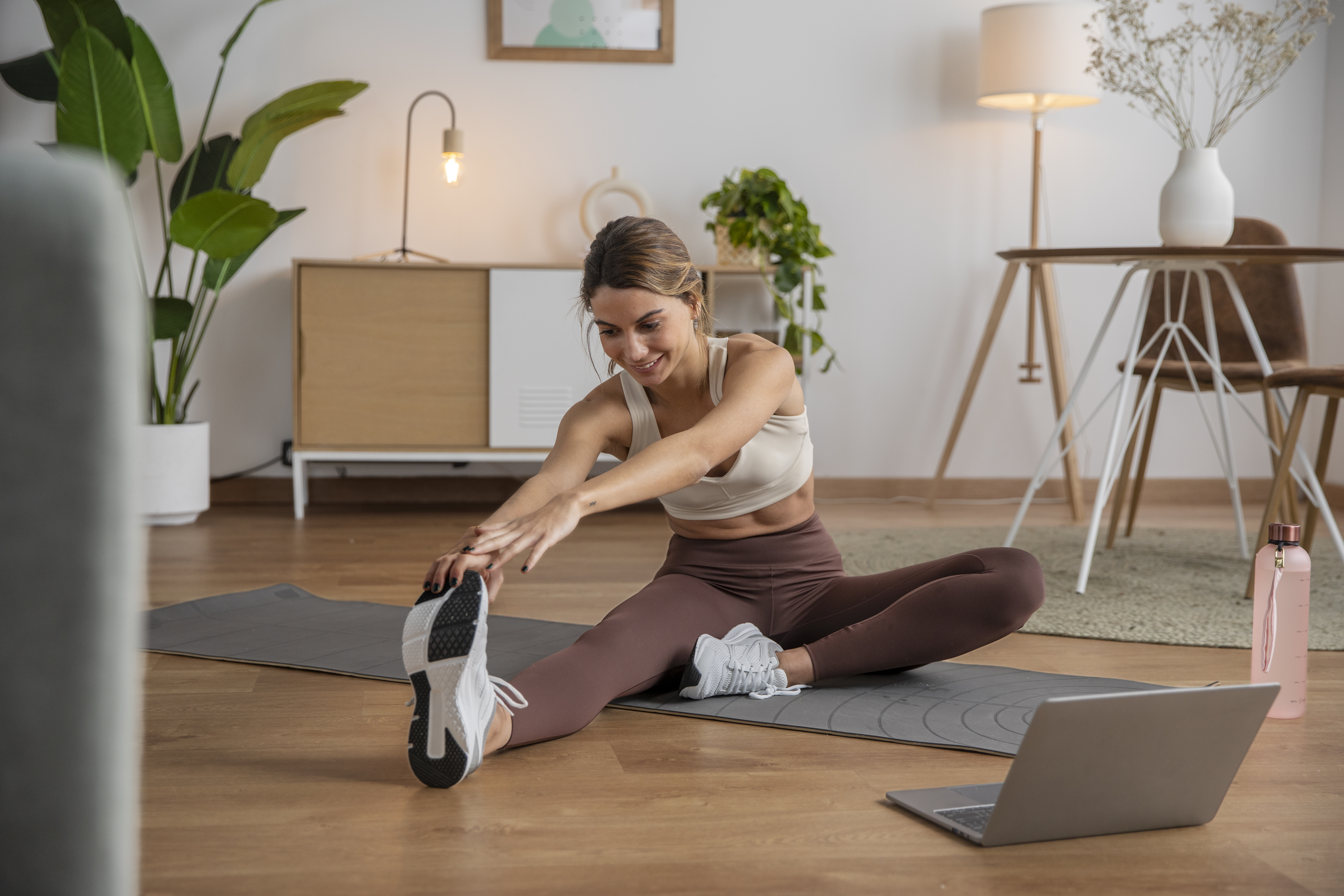 Woman stretching and exercising indoors during her travels