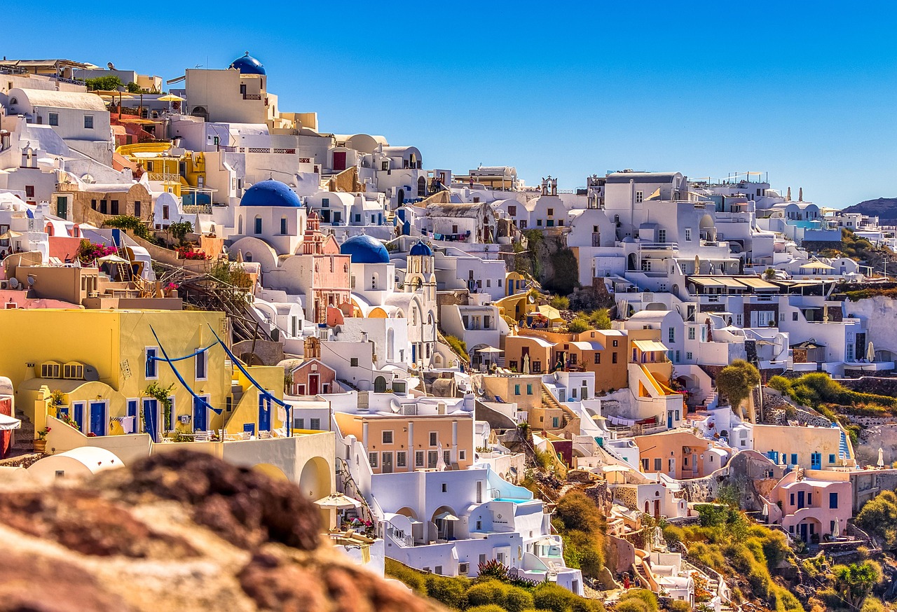 A breathtaking view of the white-washed buildings of Santorini, Greece, perched on the cliffs overlooking the Aegean Sea